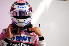 Sergio Perez, Racing Point, puts on his helmet in the garage
